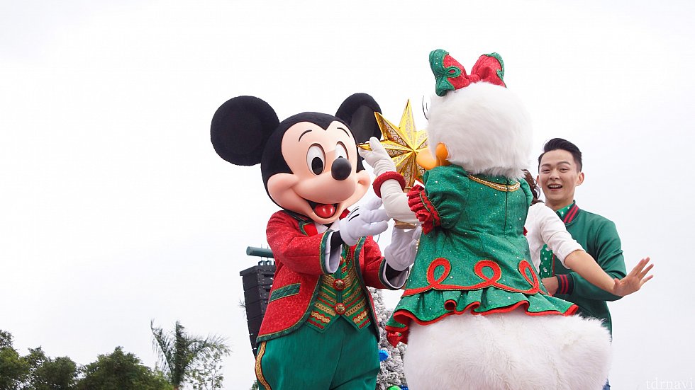 デイジーがミッキーにクリスマスツリーには欠かせない物を渡します。